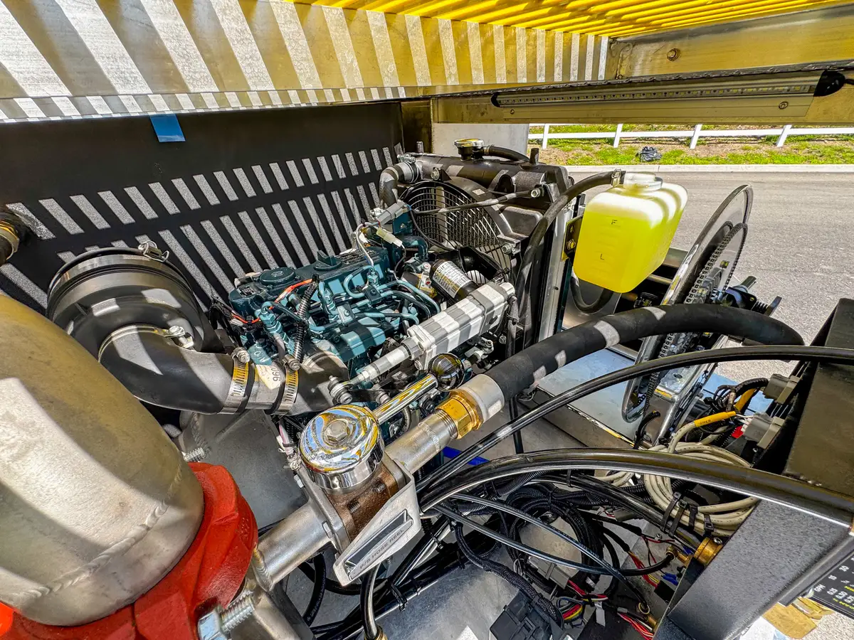 Underside rear-deck close-up showing structural supports and mounted equipment.